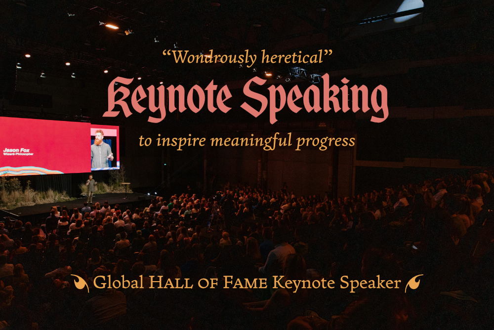 “Wondrously heretical” Keynote Speaking to inspire meaningful progress—beyond the default. This image shows global hall of fame keynote speaker Dr. Jason Fox on stage in front of a large audience.